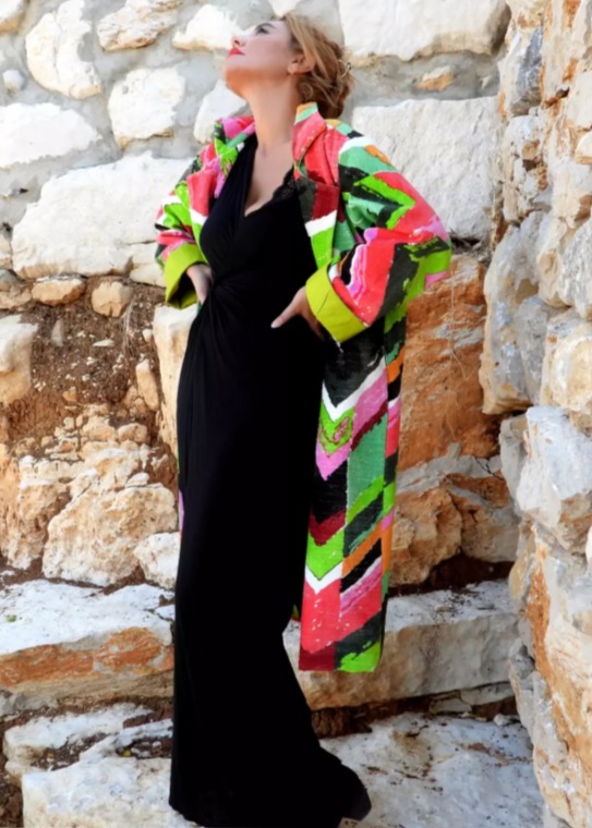 Roula Harb — Geometric Painted Coat, side view on stone wall