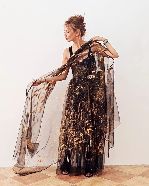Roula Harb — Black & Gold Sheer Dress, holding fabric